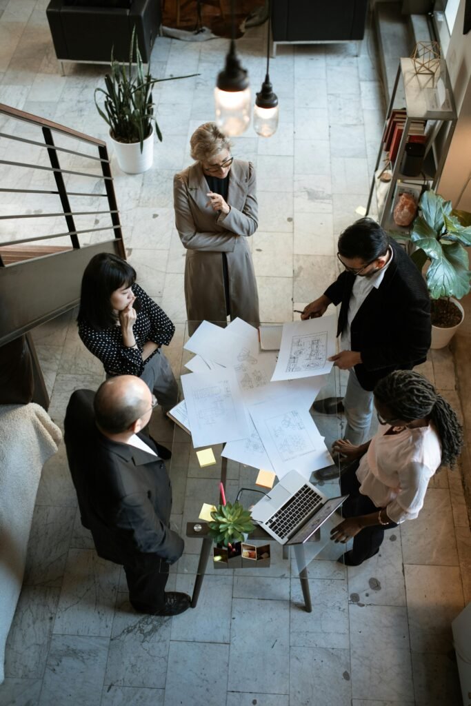 pexels-photo-5922204-5922204 A team of professionals engage in a business meeting in a sleek, modern office setting.